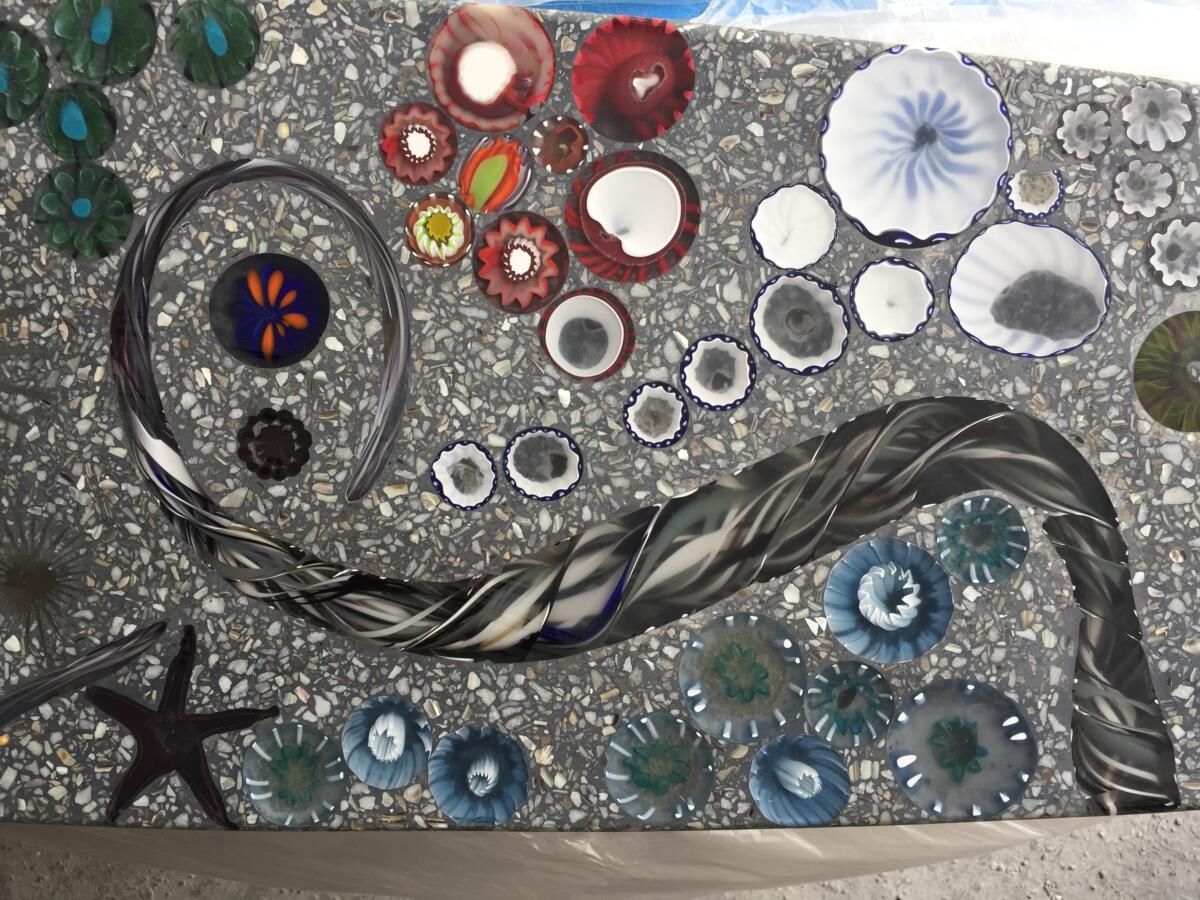 A painting of seashells and flowers on a wall