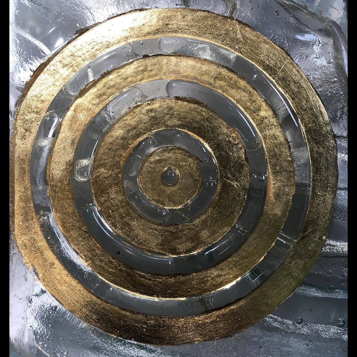 A gold and silver circle with a hole in the middle