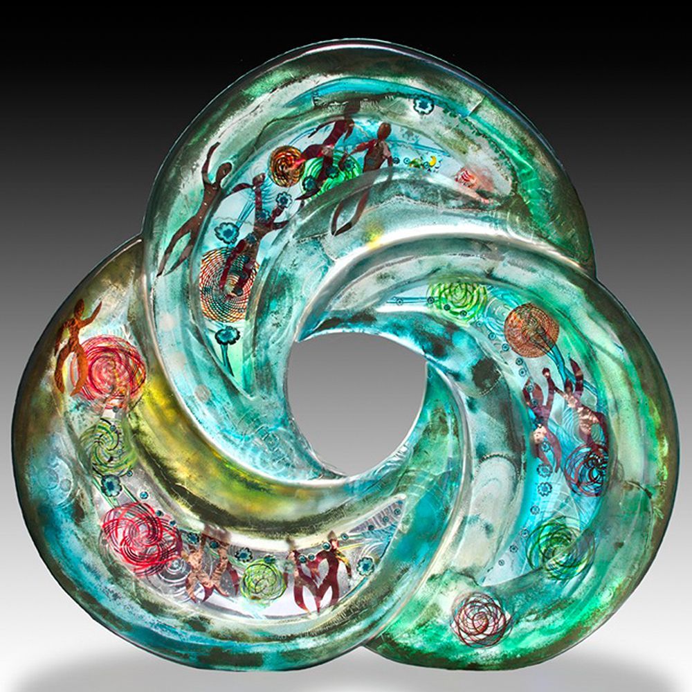 A glass sculpture of a swirl with a hole in the middle
