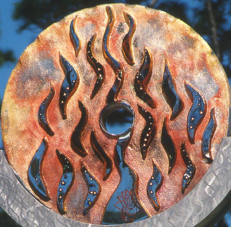 A close up of a cd with flames on it