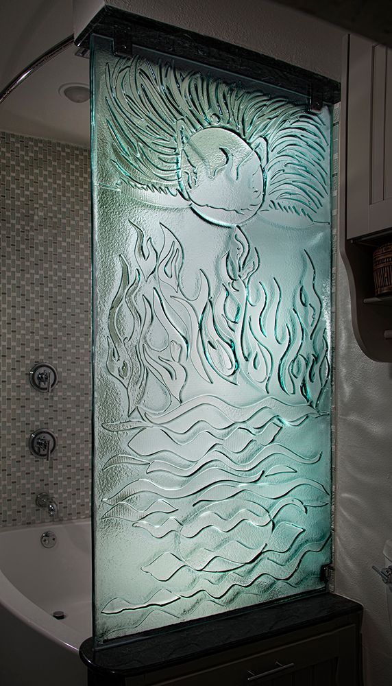 A bathroom with a bathtub and a glass wall with a picture of a fish on it.