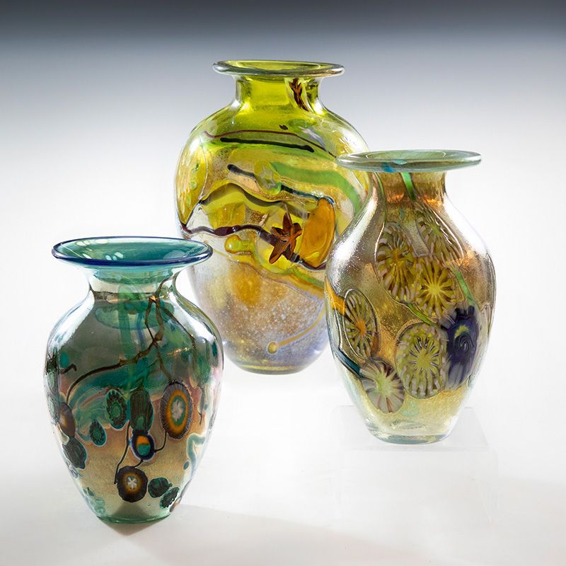 Three vases are sitting next to each other on a white surface