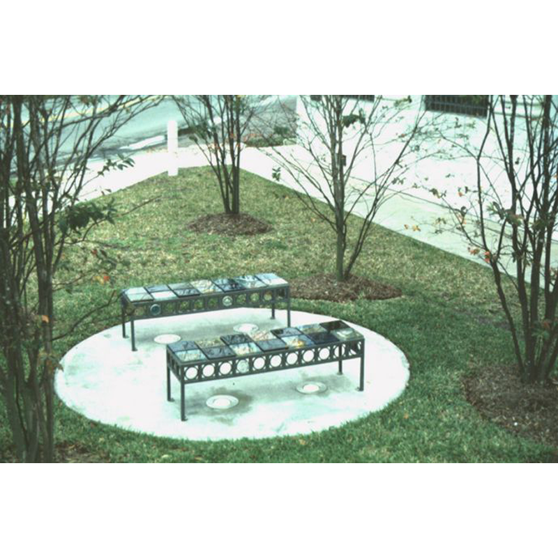 Two benches are sitting in a circle in the grass