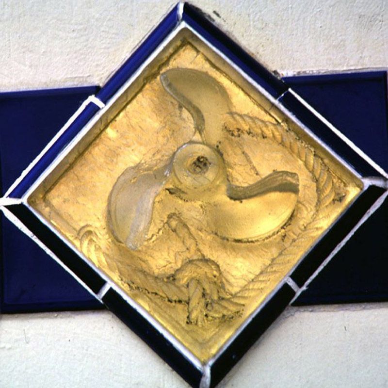 A diamond shaped plaque with a propeller on it