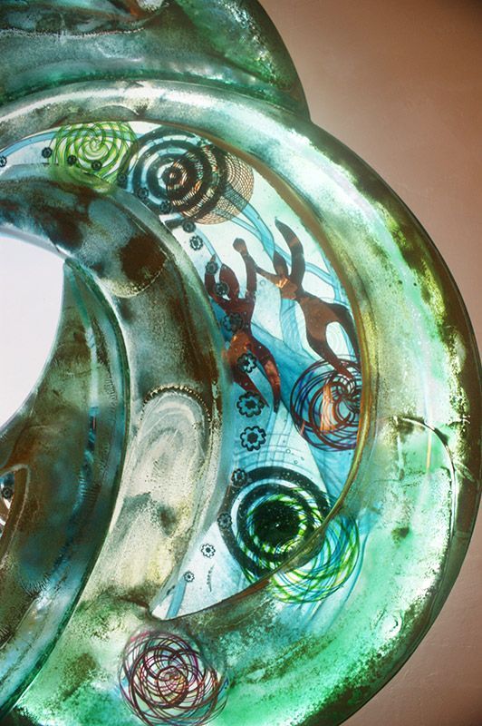 A close up of a green glass sculpture on a table.