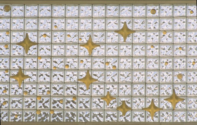 A wall with a lot of squares and gold stars on it.