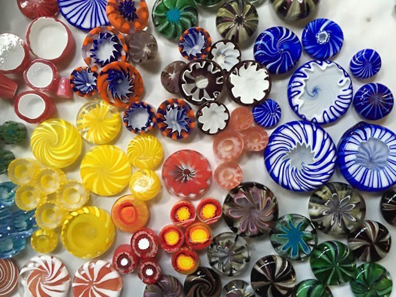 A bunch of different colored glass beads on a table