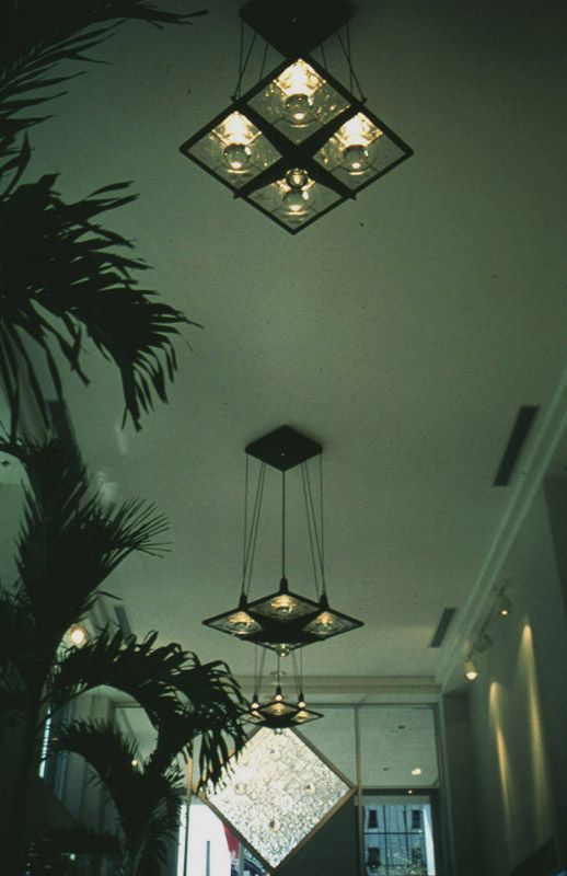A ceiling with four square lights hanging from it