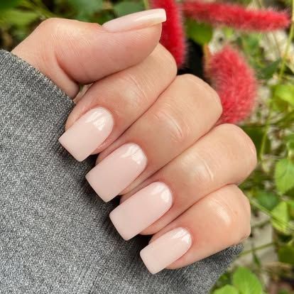 A close up of a person 's nails with a pink nail polish.