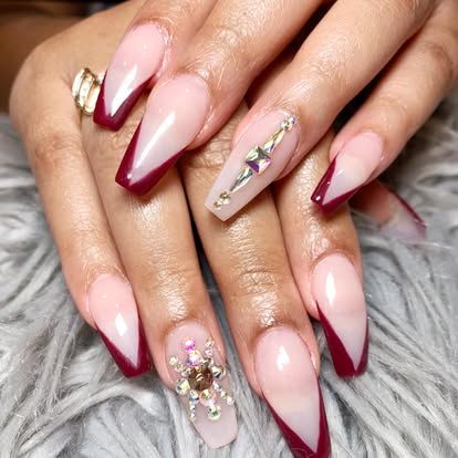 A close up of a woman 's nails with a ring on her finger.