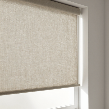 Beige roller blind partially covering a window with white trim