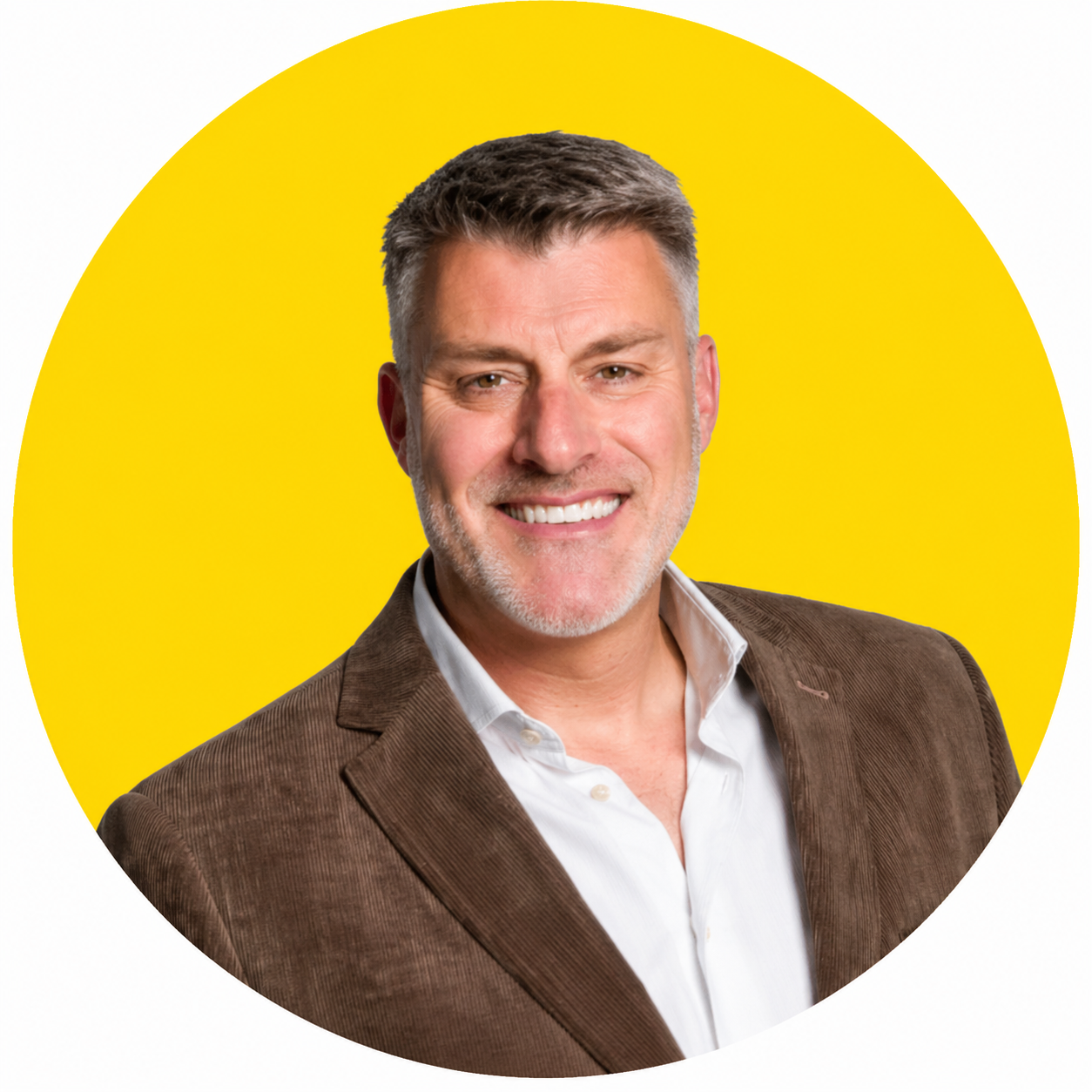 A man wearing glasses and a black sweater is standing in a yellow circle.