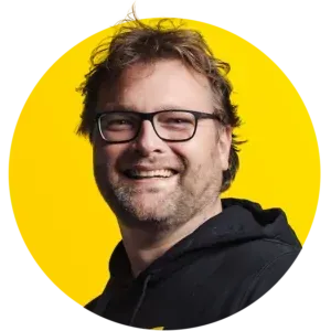 A woman in a black shirt is smiling in a yellow circle