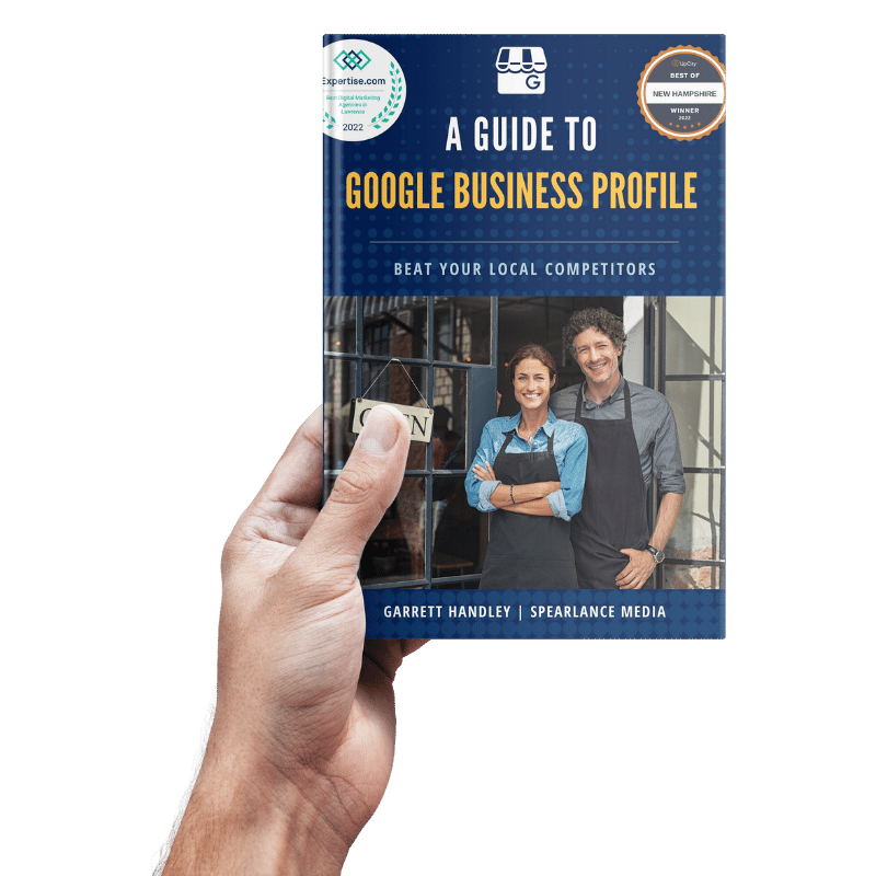 Hand holding a blue book titled “A Guide to Google Business Profile” with a smiling couple on the cover