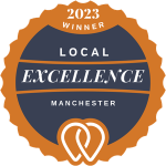 2023 Local Excellence Award badge for Manchester in orange and navy blue with white text