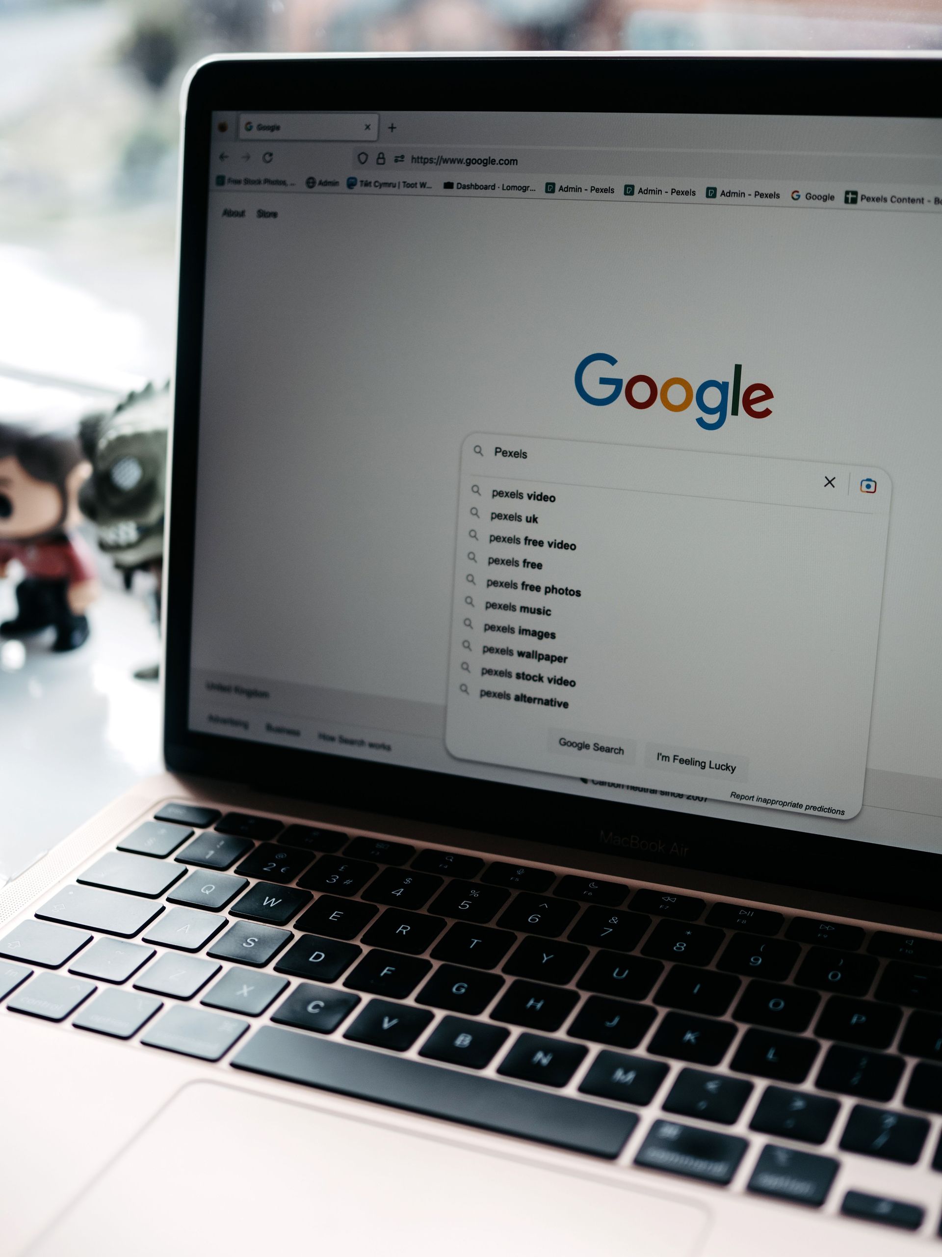 Laptop showing Google search page with autocomplete suggestions open