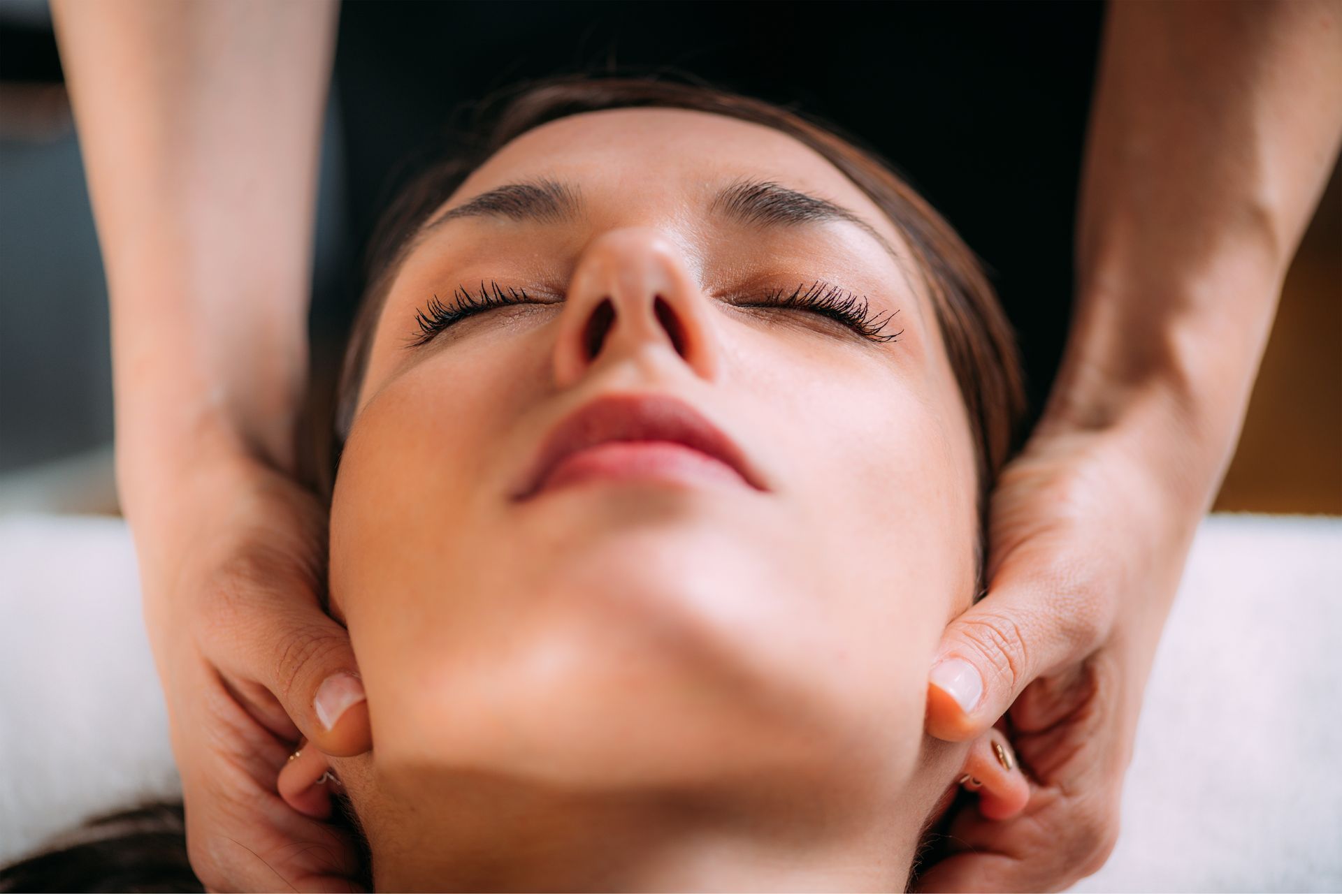 Cranial osteopathy massage. Therapist massaging woman’s head.