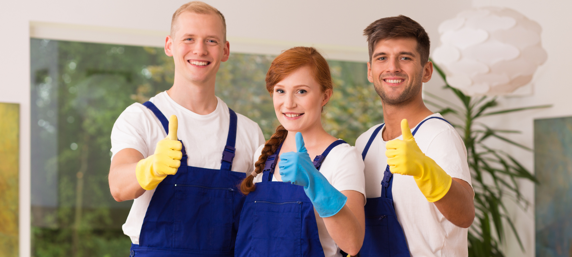A happy team of professional Airbnb cleaners in Las Vegas giving a thumbs up.