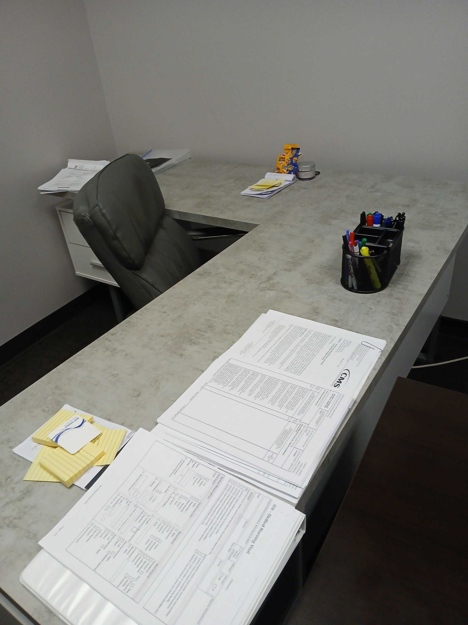A desk with a lot of papers on it
