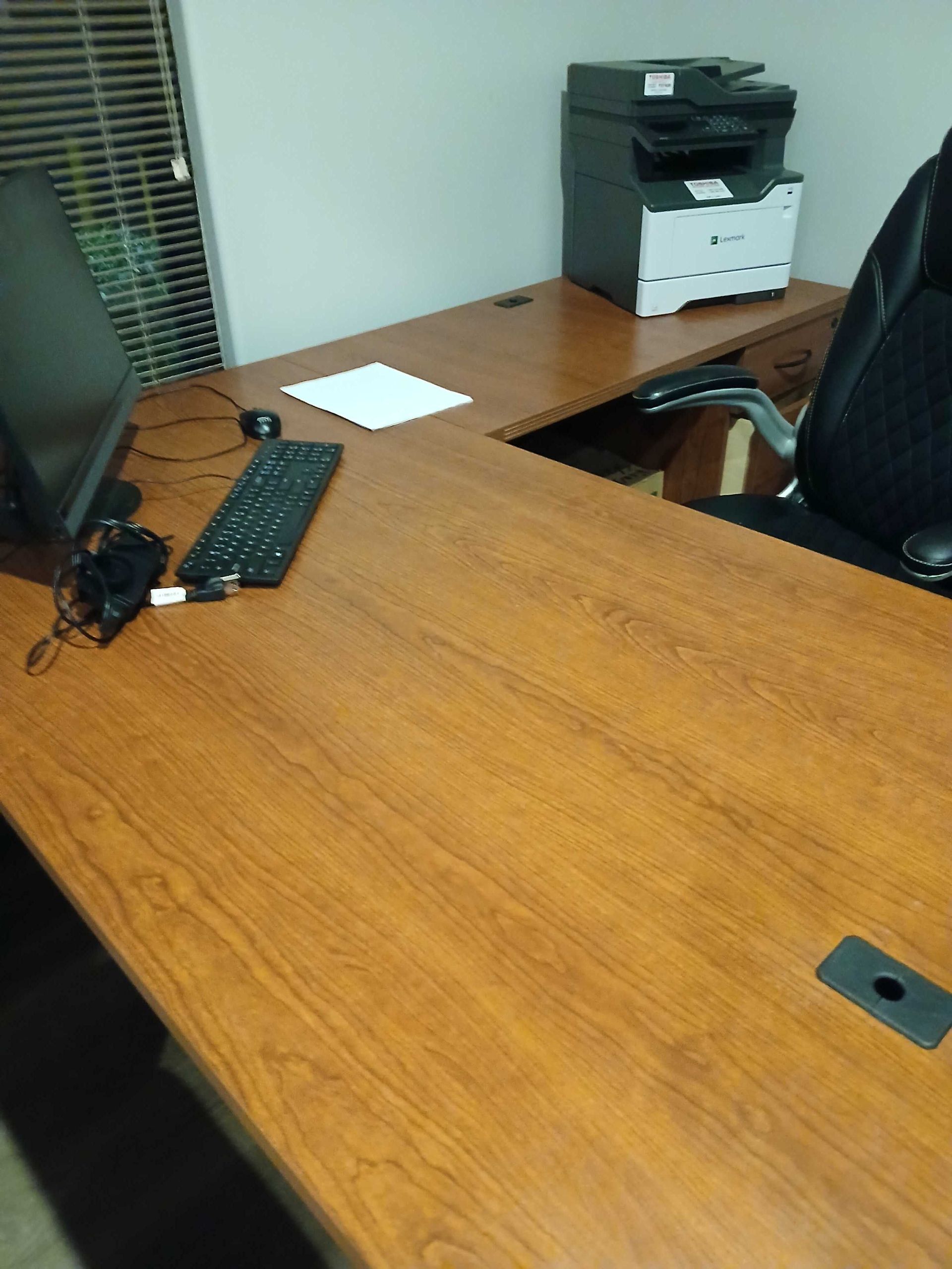 A desk with a computer and a printer on it
