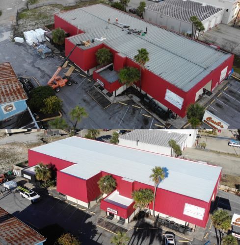 An aerial view of a large red building with a white roof