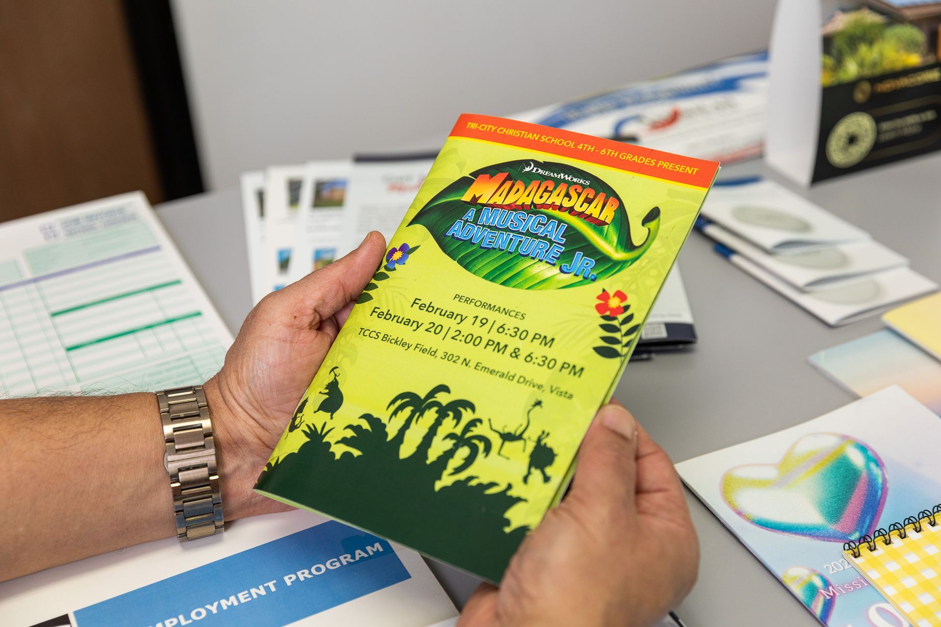 Person holding a brochure for a