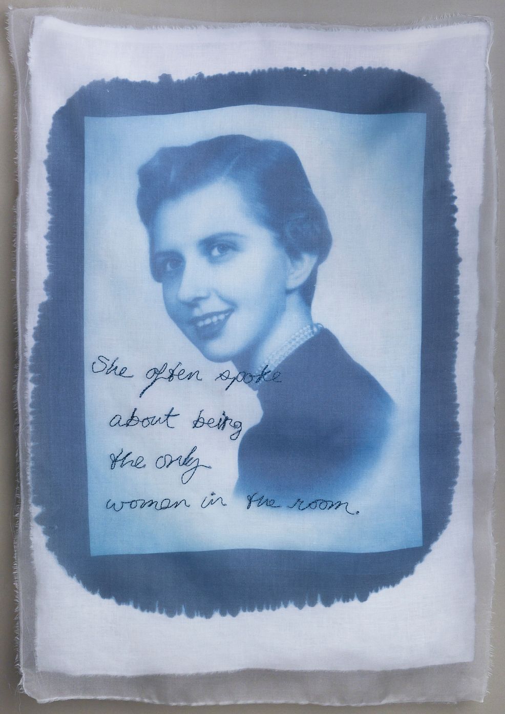 Blue portrait print of a smiling woman with handwritten text underneath