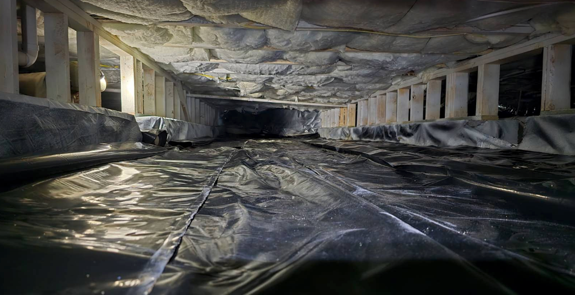 Crawlspace with reflective water and crumbling concrete walls and ceiling