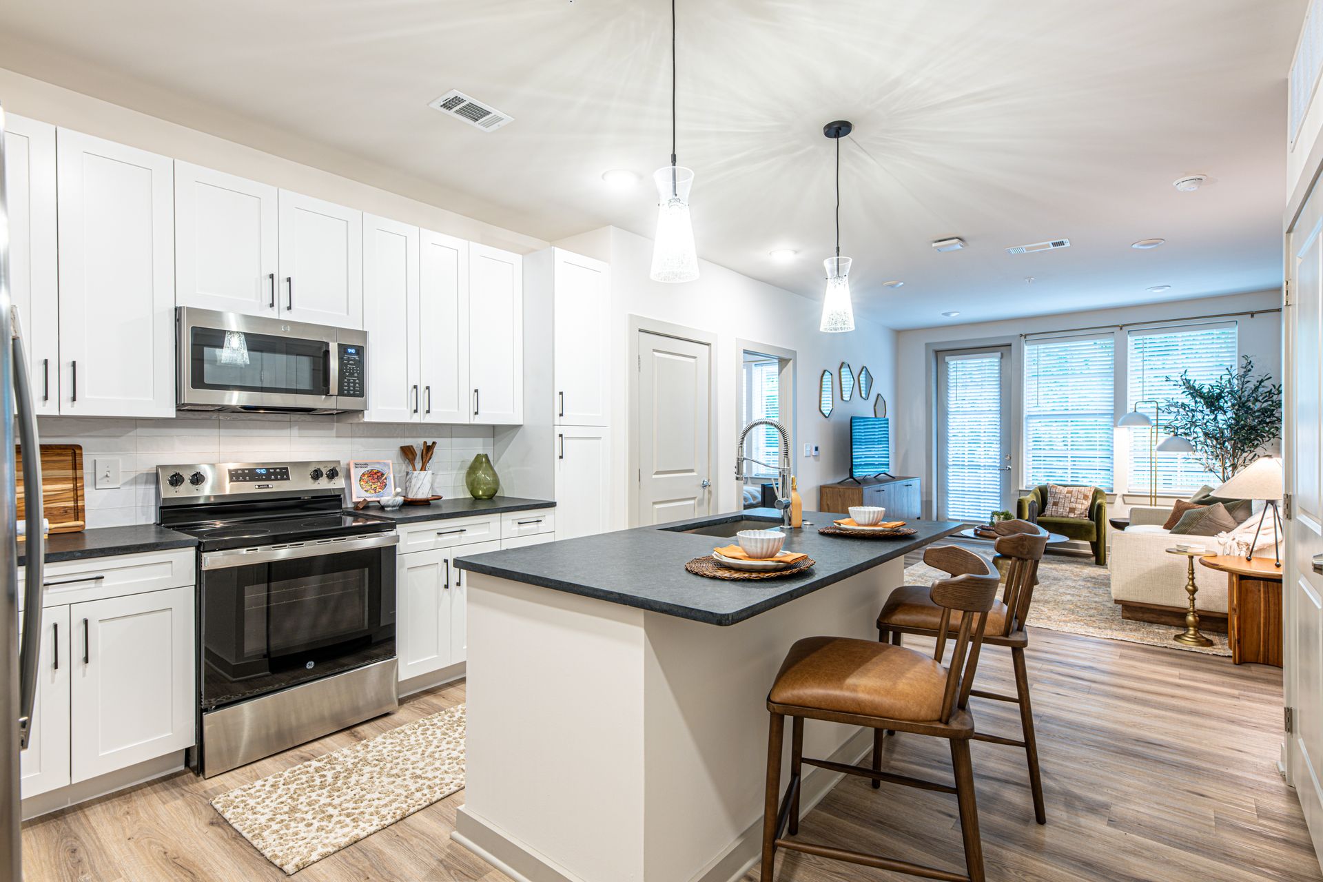 An artist 's impression of the apartment community lobby with a couch and chairs
