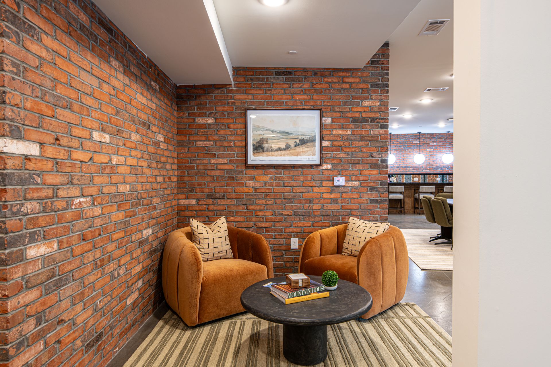 An artist 's impression of the apartment community lobby with a couch and chairs