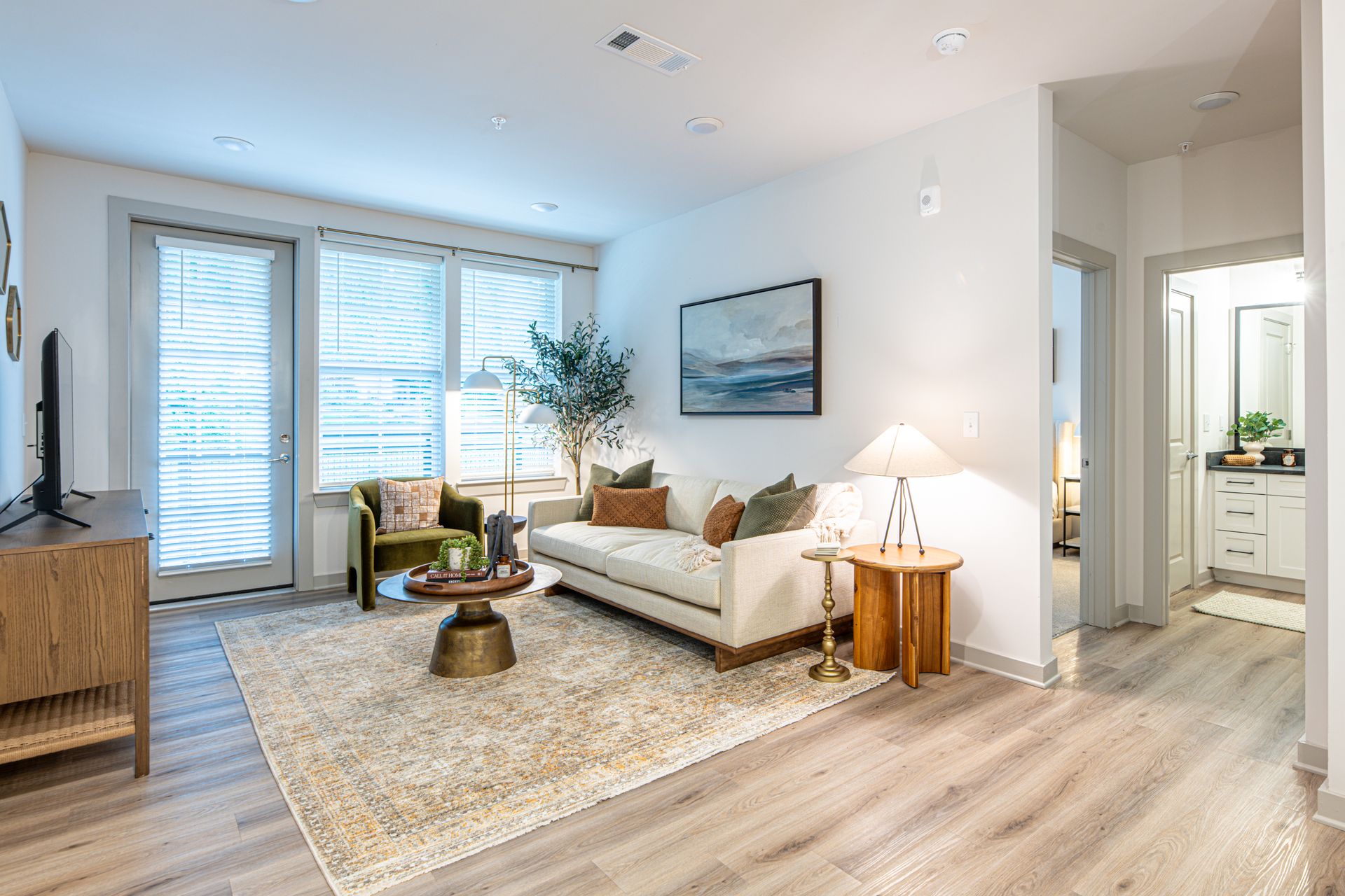 A living room with a couch , coffee table , and television.