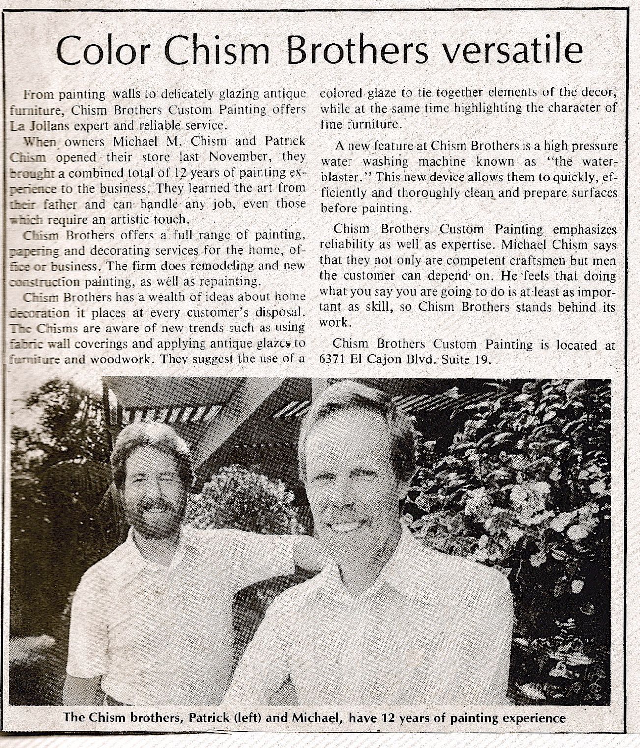 Two men, Michael and Daniel Chism, pose for a newspaper article about their painting business.