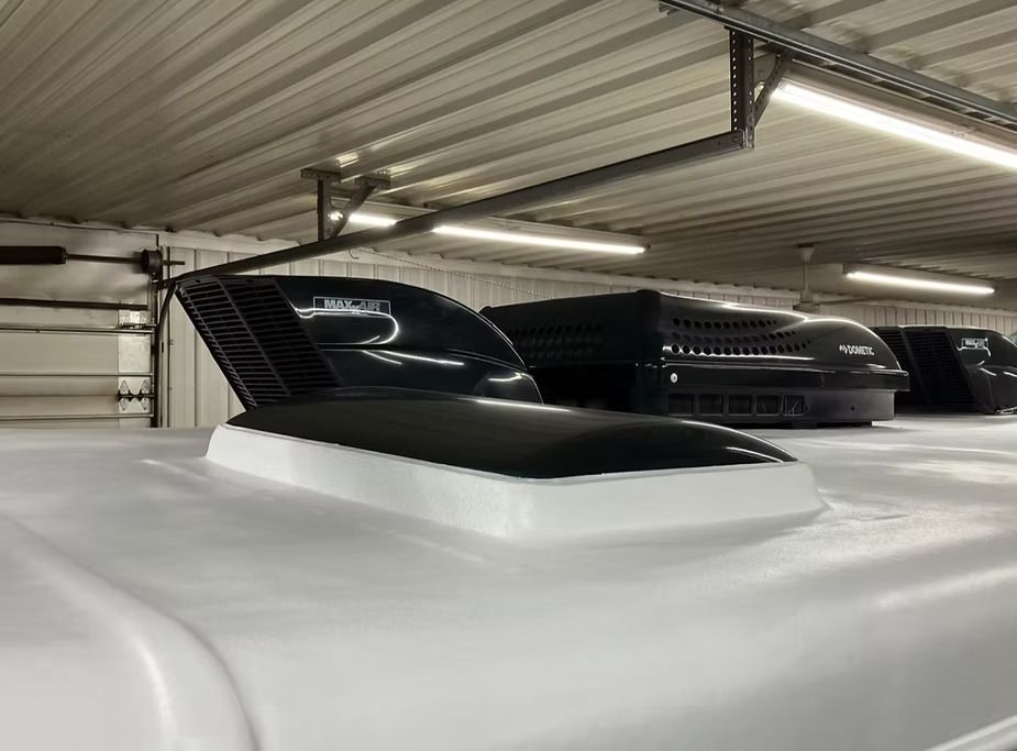 White RV roof with black vent covers.