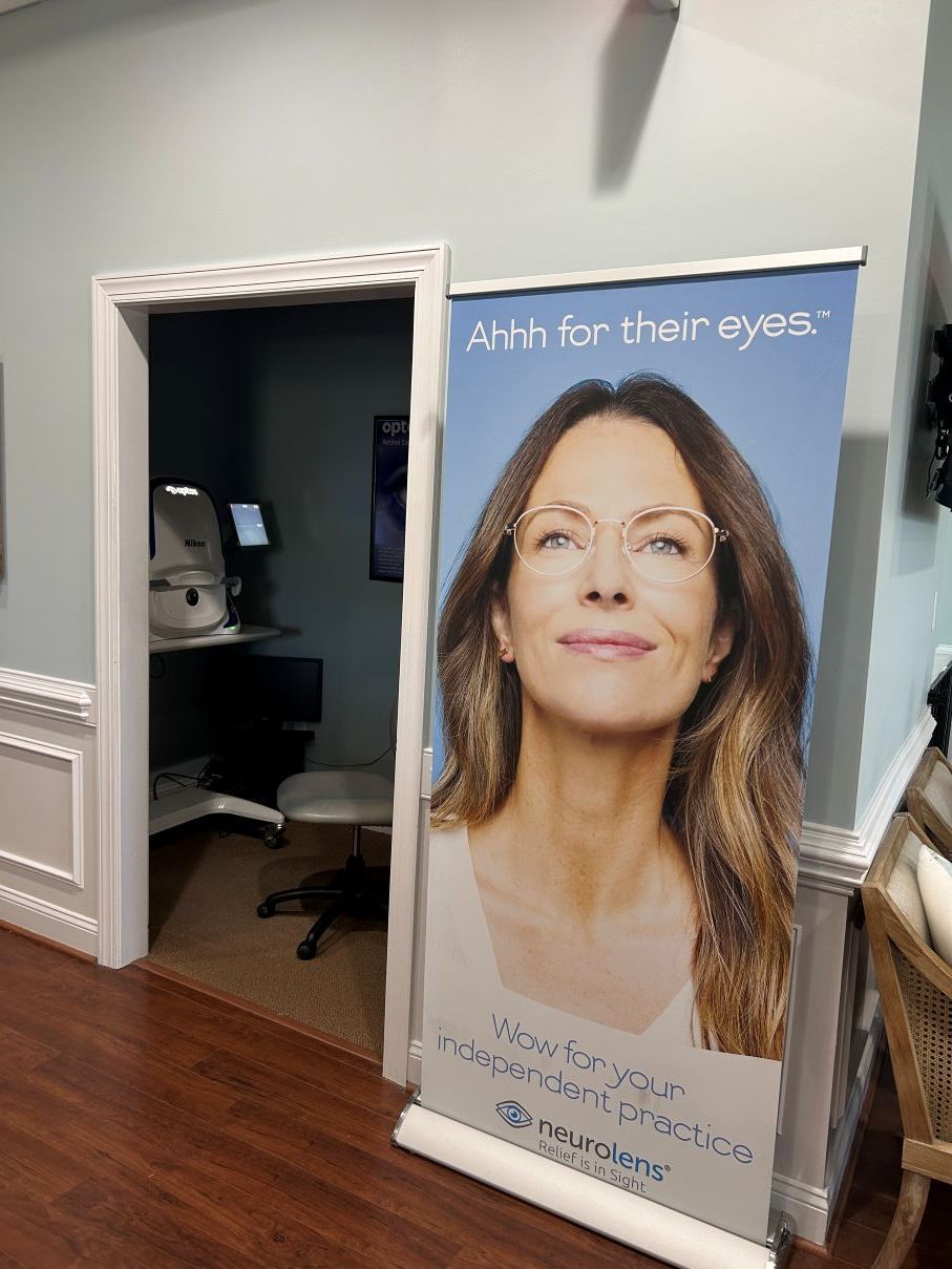 Open doorway beside a banner with a woman in glasses promoting eyes-on-your-eyes surgery in Hope Mills, NC.
