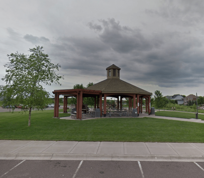 A gazebo in a park on a cloudy day