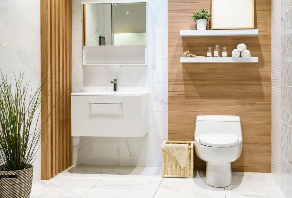 A Bathroom with a Toilet, Sink and Mirror — Hunter Valley Tile Mart in Cessnock, NSW