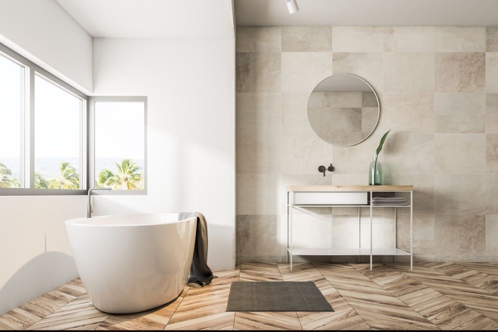 A Bathroom with a tub, sink, mirror and Window — Hunter Valley Tile Mart in Maitland, NSW
