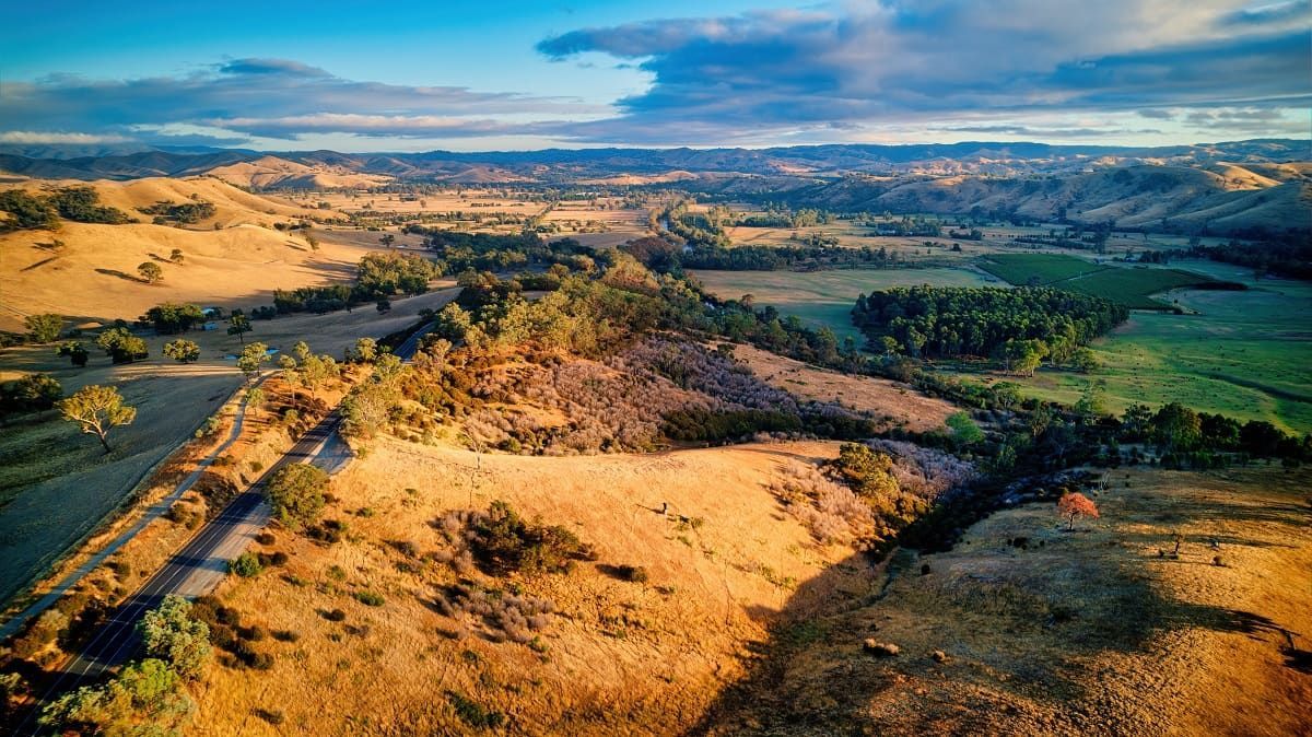 An Aerial View of A Desert Landscape with A Road Going Through It — Hunter Valley Tile Mart in Thorntorn, NSW