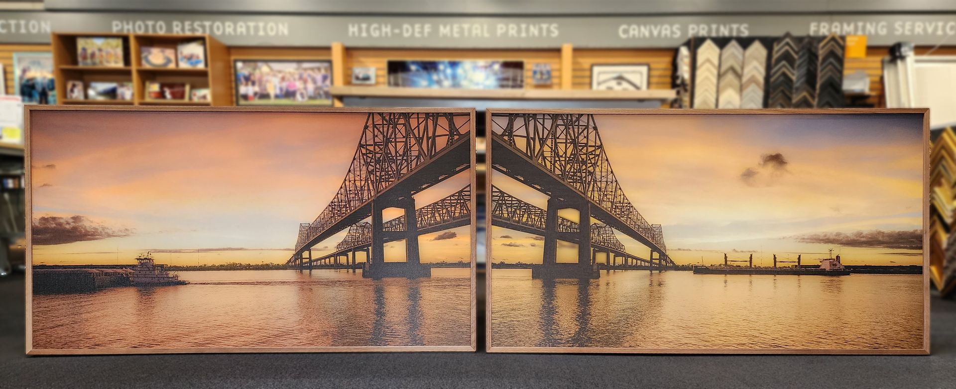 Large wall mural of a sunset bridge scene with city skyline, in a train station interior