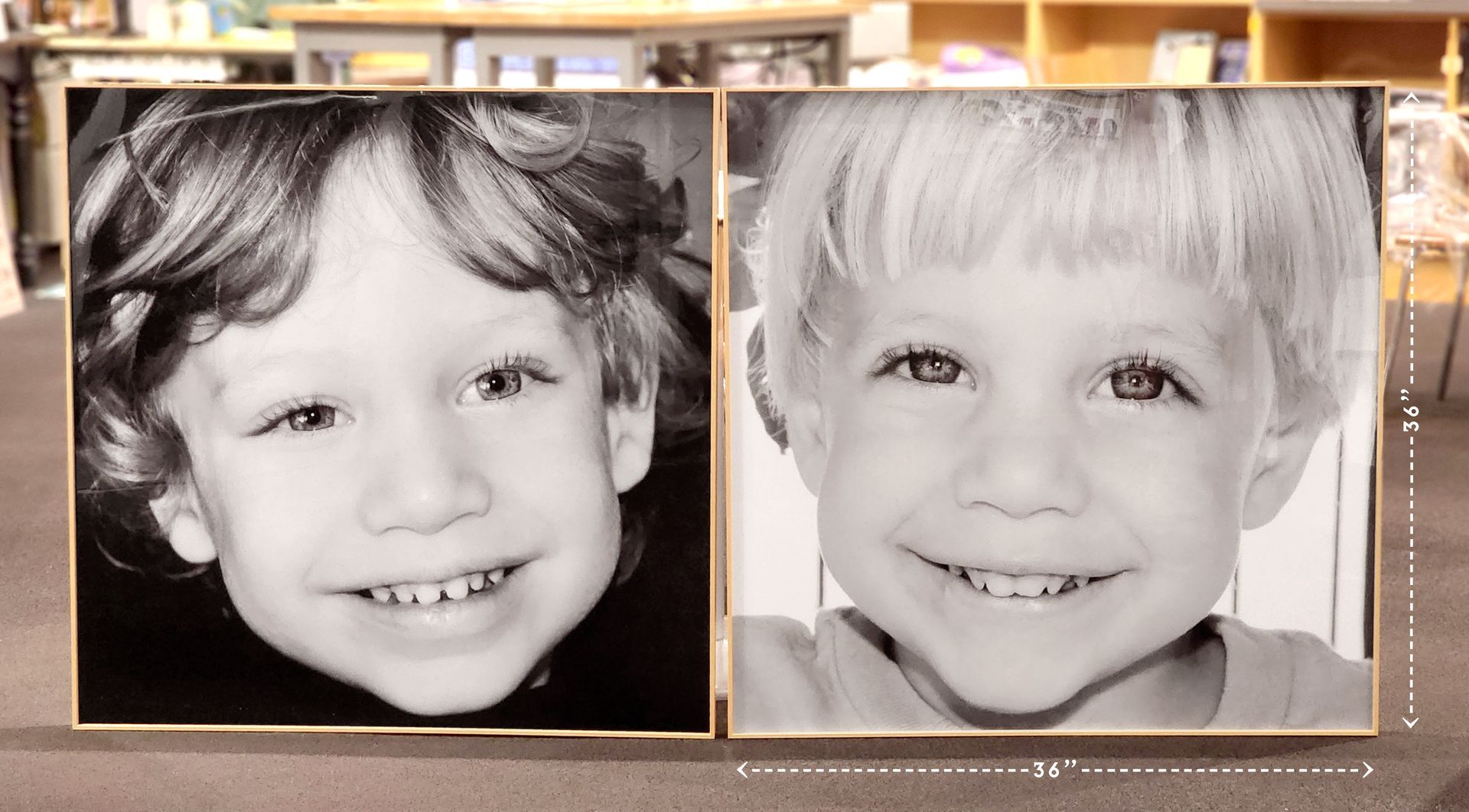 Two black-and-white child portraits side by side, both smiling in framed photos