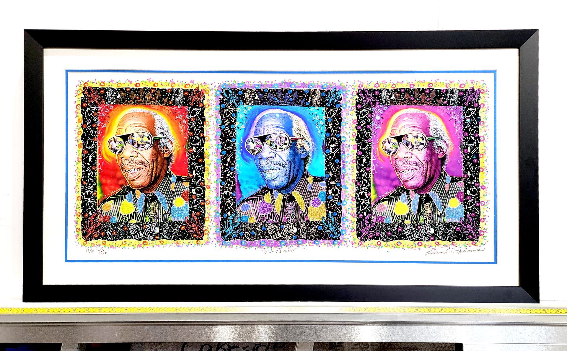 Framed pop-art triptych of colorful stylized faces on a white background