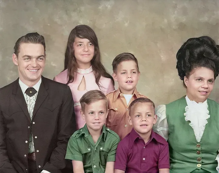 Five people in vintage clothing posing for a formal studio portrait