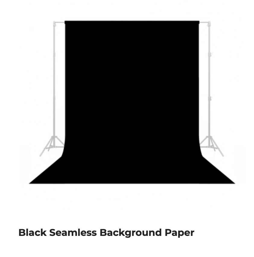 Black seamless background paper on stands, forming a curved black studio backdrop.