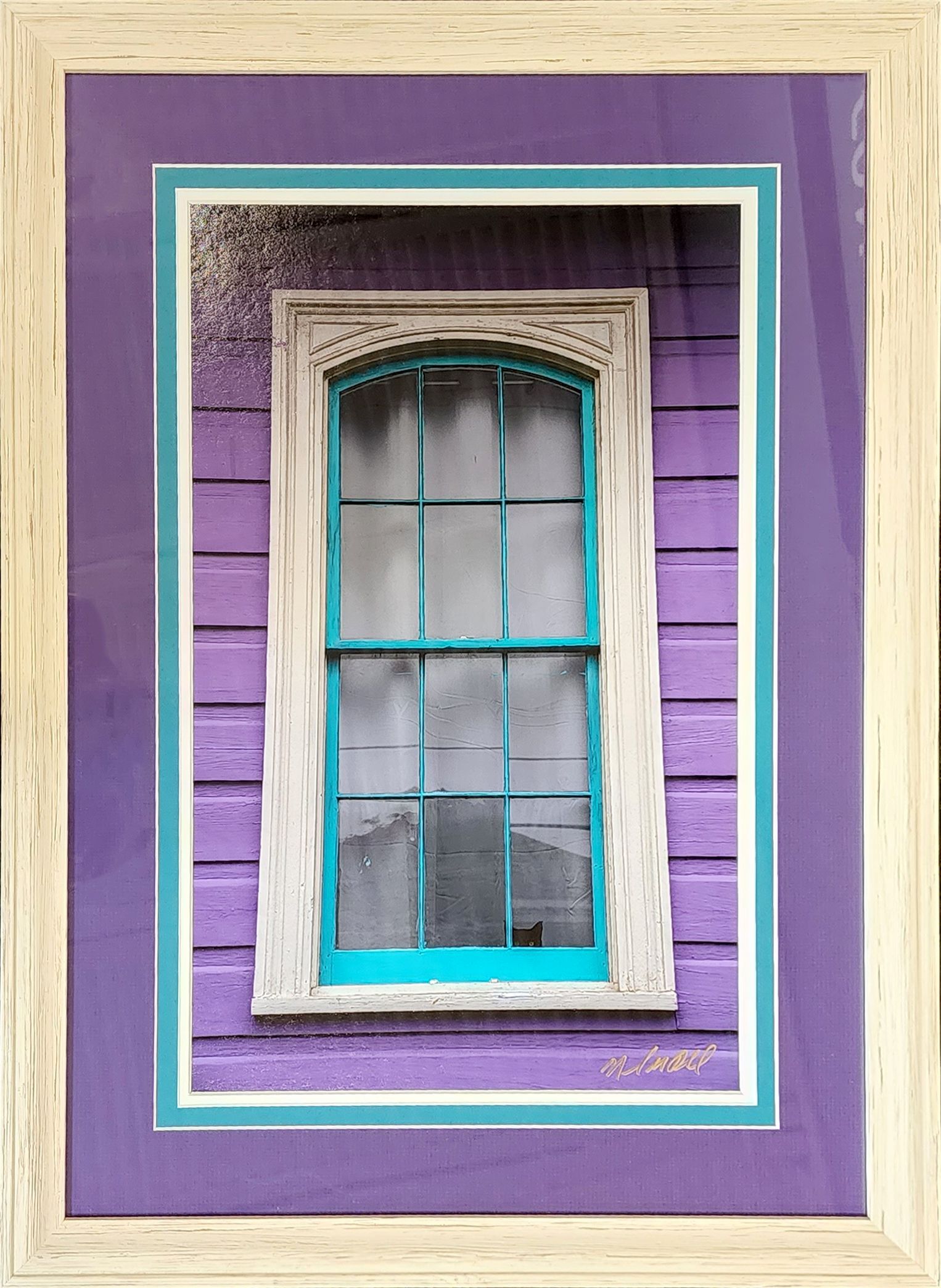 Framed purple and turquoise photo of a weathered window on a purple wall