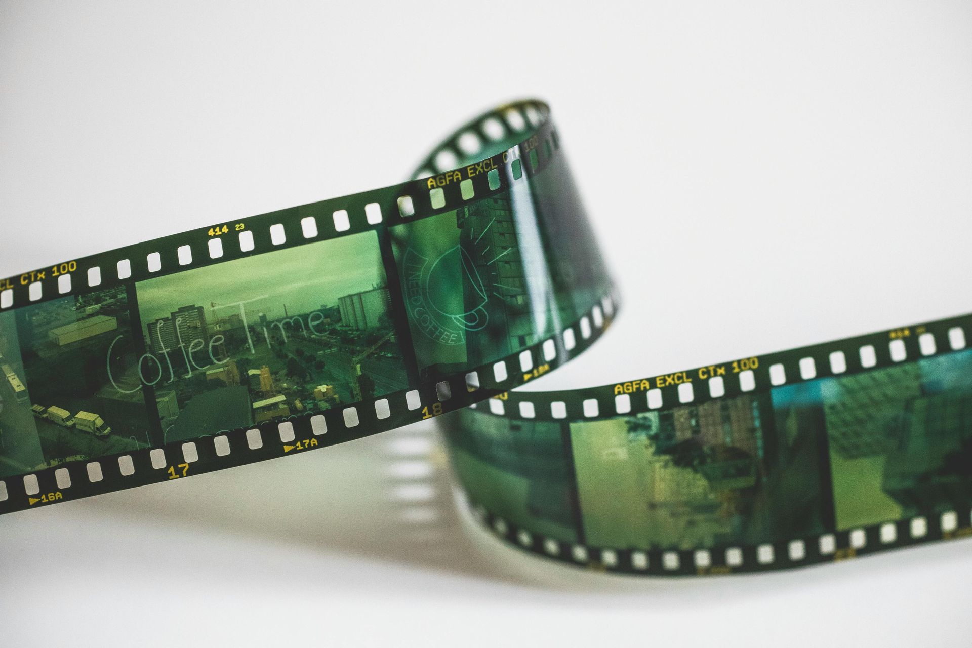 Green film strip curling on a white background