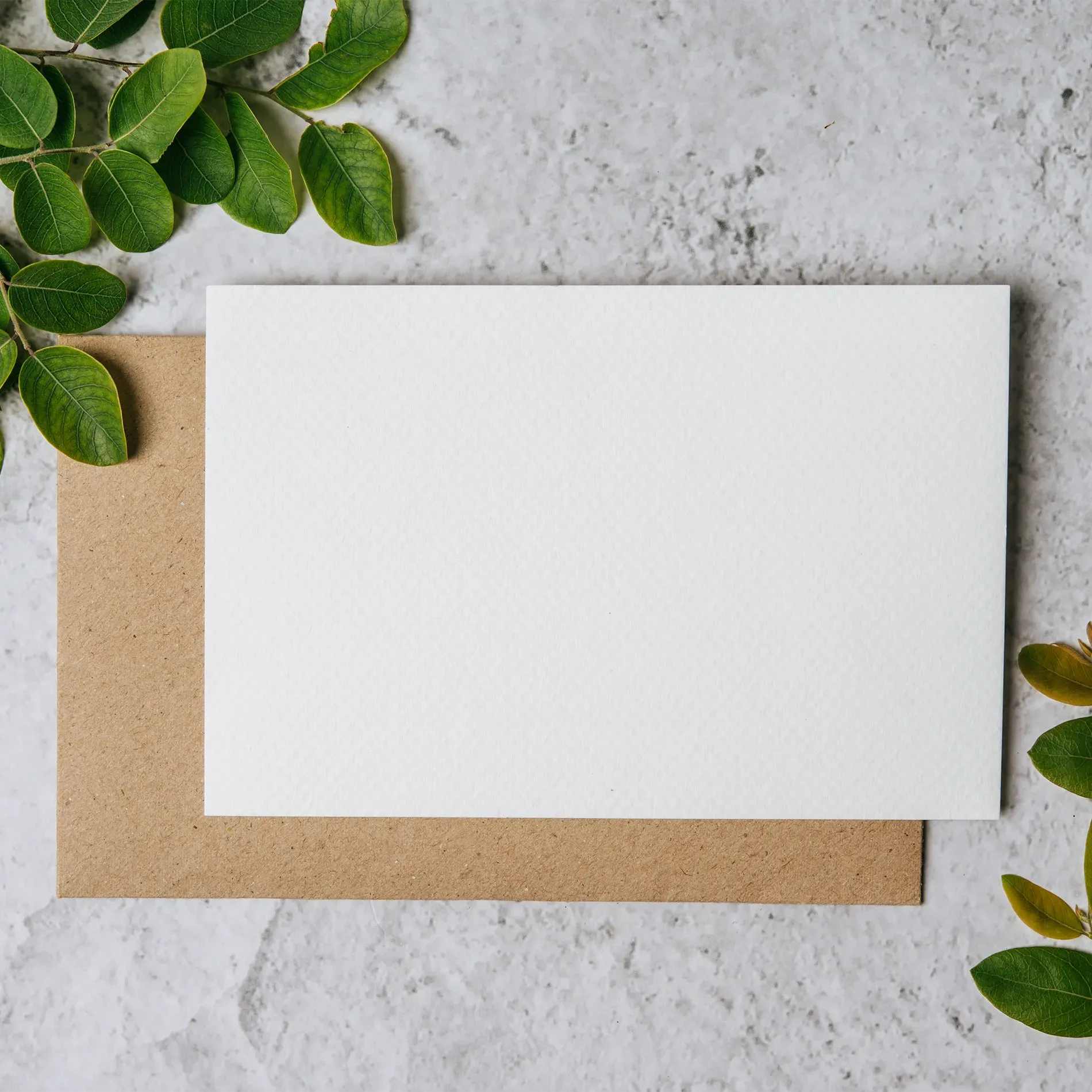 Blank Card with Kraft Envelope on Table