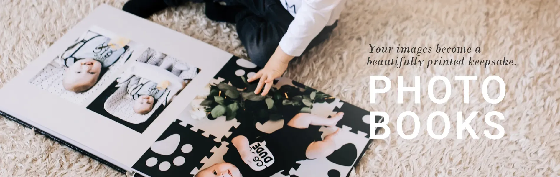 Open photo books on a table with black-and-white family photos and floral pages, plus a hand arranging pieces.