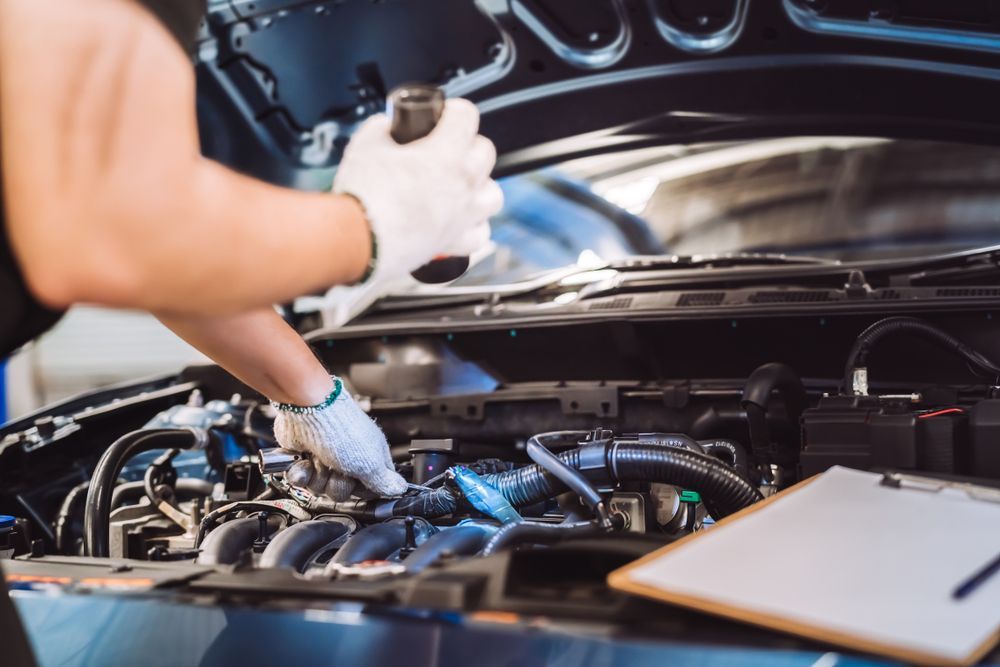 A Mechanic is in Front of a Car Checking the Engine — Jim Wall Automotive in Mittagong, NSW
