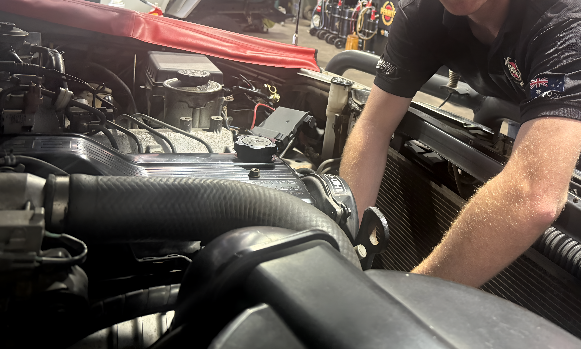 A Man is Working on the Engine of a Car in a Garage — Jim Wall Automotive in Mittagong, NSW