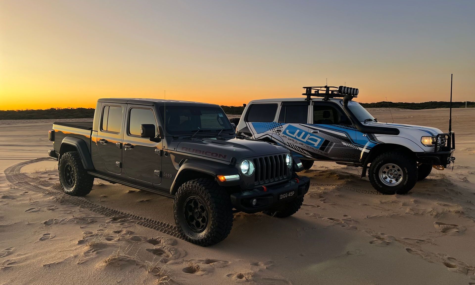 Two cars parked on sand — Jim Wall Automotive in Mittagong, NSW